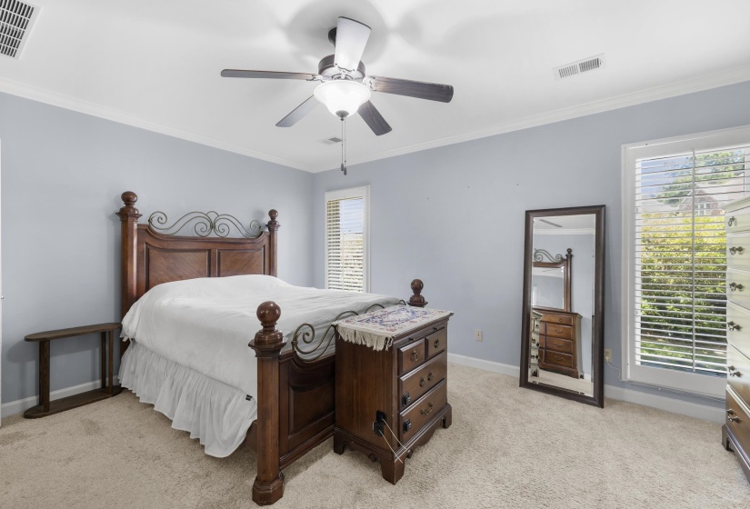 Carpeted room featuring light blue walls, white trim, and a ceiling fan with integrated lighting