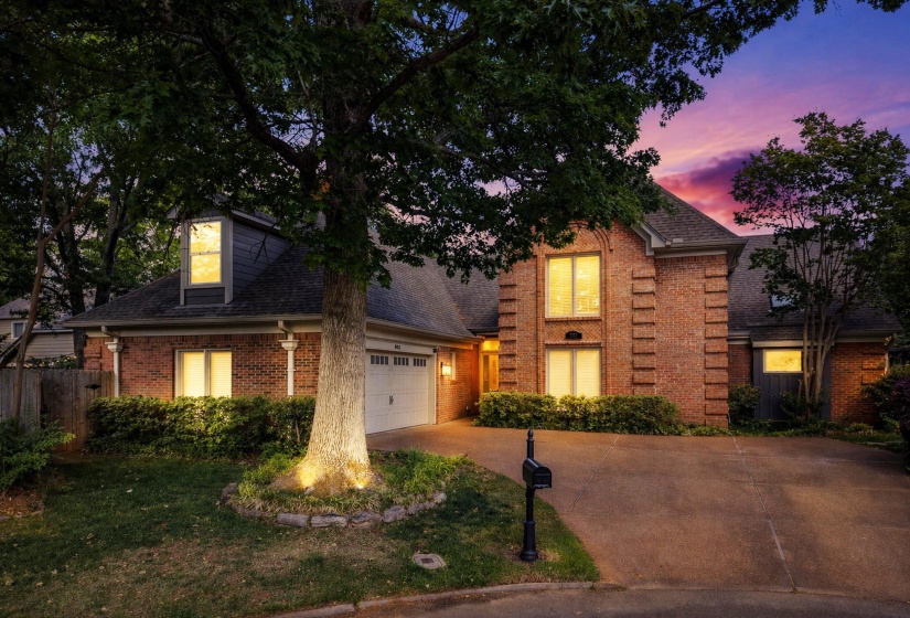 Brick exterior residence featuring a gabled roofline and dormer windows