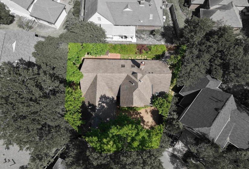 Aerial perspective showcasing a property surrounded by mature trees