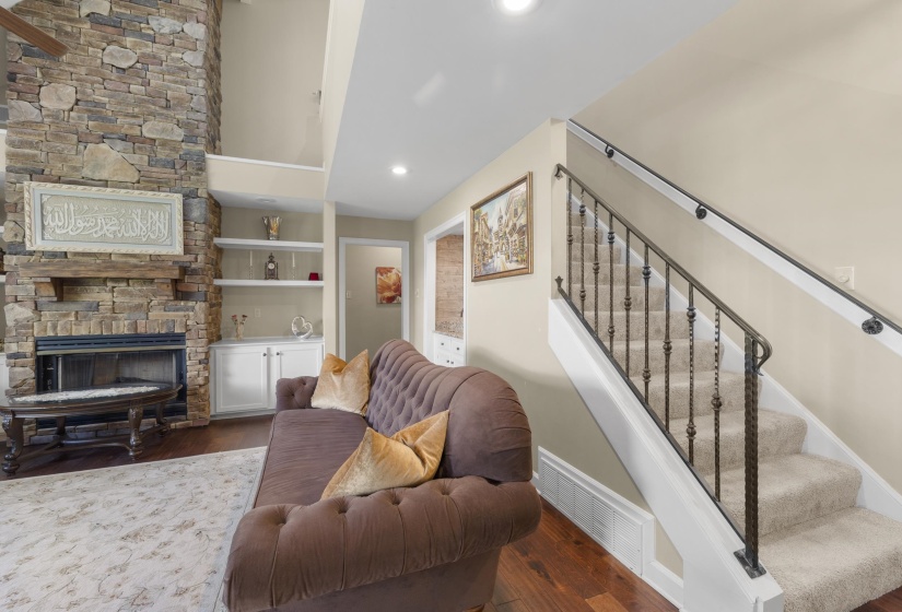 Stone-clad fireplace with a wood mantle