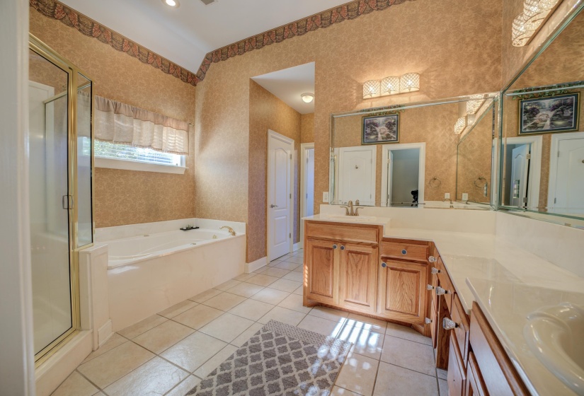 Bathroom with tile patterned flooring, vanity, and independent shower and bath