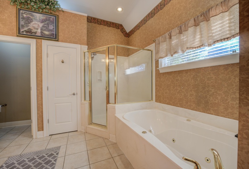 Bathroom featuring tile patterned floors and plus walk in shower