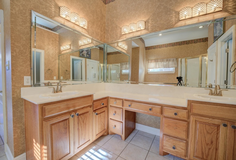 Bathroom with tile patterned flooring, vanity, and a shower with door