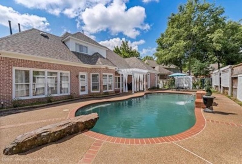 View of pool with a patio and pool water feature