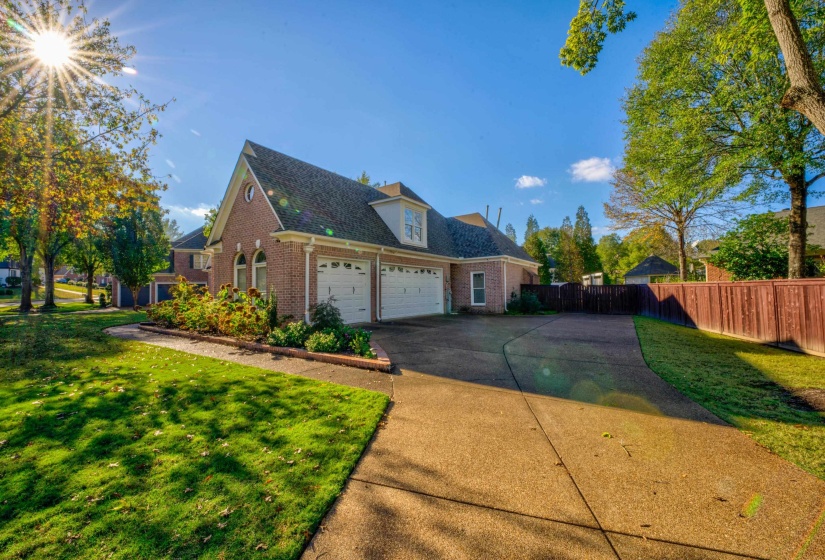 View of side of property with a yard and a garage