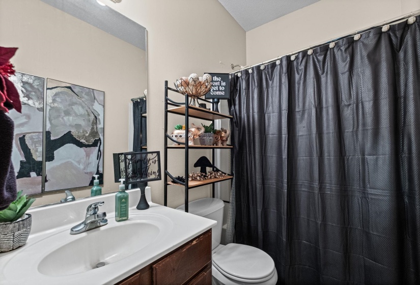 Bathroom vanity featuring a single basin sink and chrome faucet