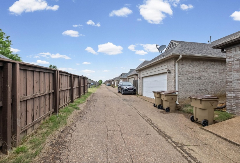 Rear-entry garages featuring a brick exterior and a gable roofline