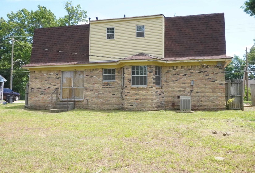 Brick exterior with an upper level featuring horizontal siding
