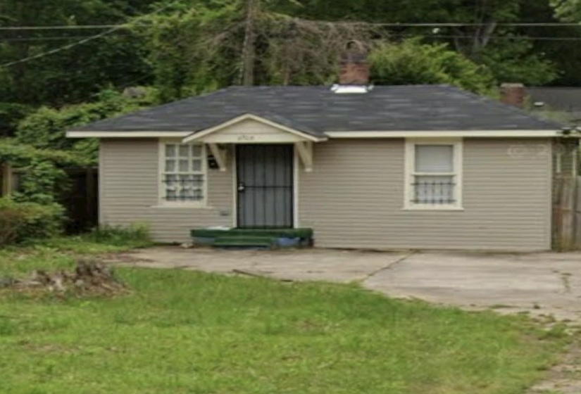 Single-story residence featuring light gray siding, a dark shingle roof, and a front entry with a security screen door