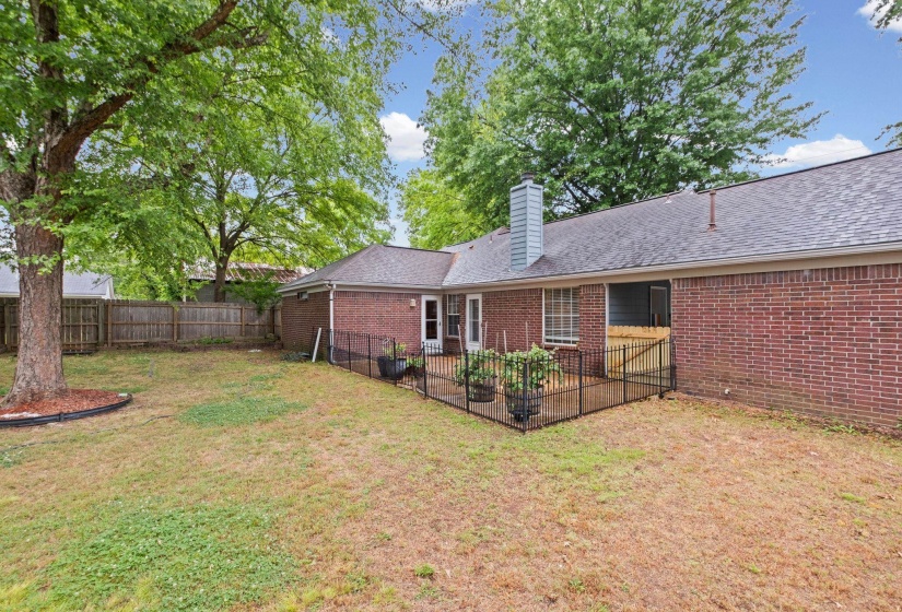 Beautiful escape in the back yard featuring a patio area, and a large shade tree