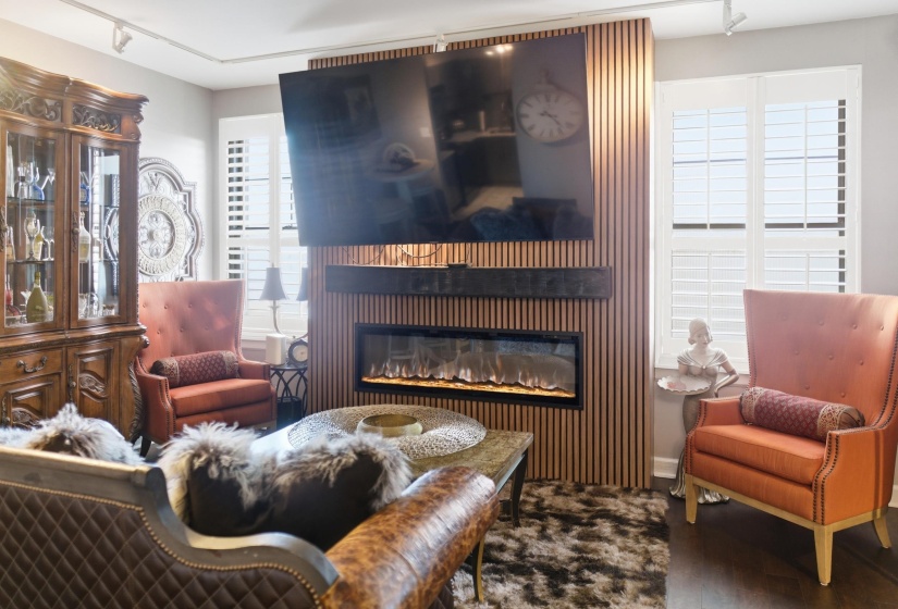Built-in fireplace with a linear firebox and wood-slat surround