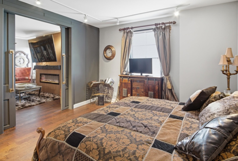 Spacious room with wood-finish flooring and light gray wall paint