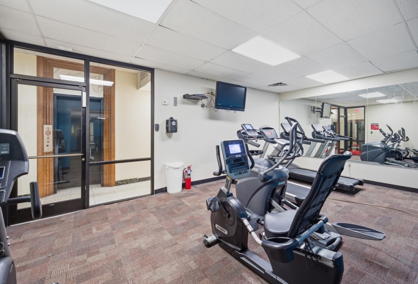 Fitness center featuring exercise equipment including treadmills, ellipticals, and stationary bikes