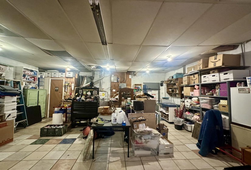 Miscellaneous room with light tile patterned floors and a drop ceiling