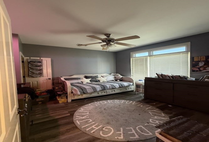 Bedroom featuring dark wood-style floors and a ceiling fan