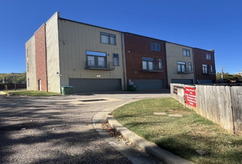 View of building exterior with an attached garage and driveway