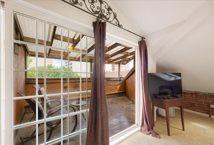 Interior space featuring carpet flooring, lofted ceiling, and baseboards