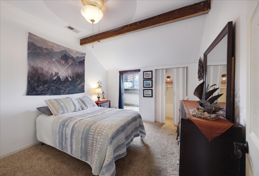 Bedroom featuring light carpet
