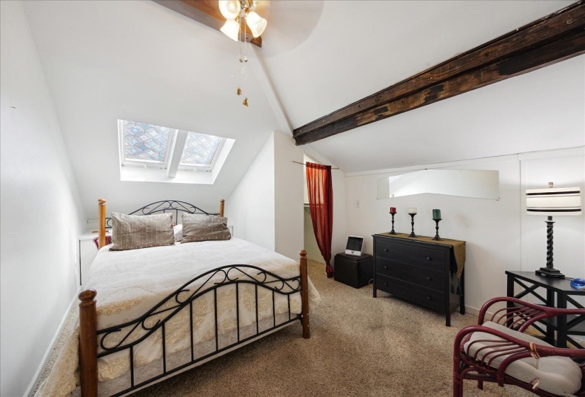 Carpeted bedroom with a skylight