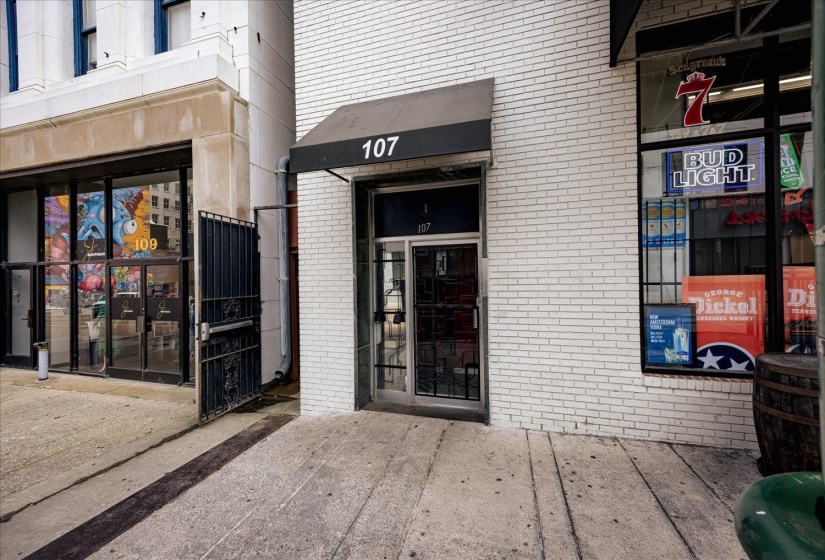 View of exterior entry with brick siding