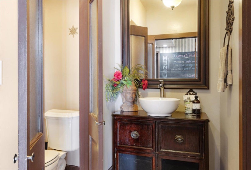 Half bath featuring toilet and vanity