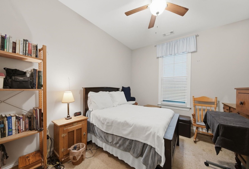 Interior room with light-toned walls and sloped ceilings