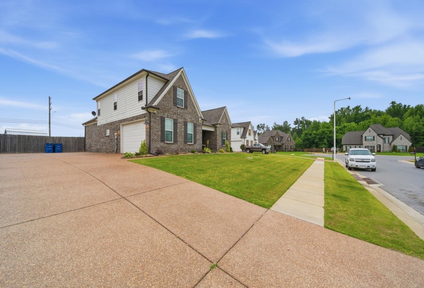 Two-story residence featuring brick and siding facade, a two-car garage, and a concrete driveway