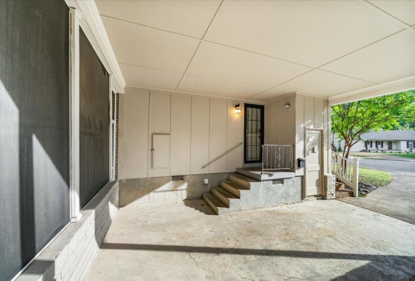 Covered carport area featuring a concrete floor and a screened exterior wall