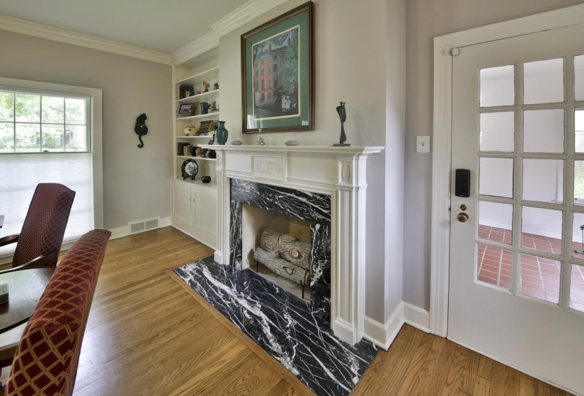 Fireplace with white mantel and black marble surround
