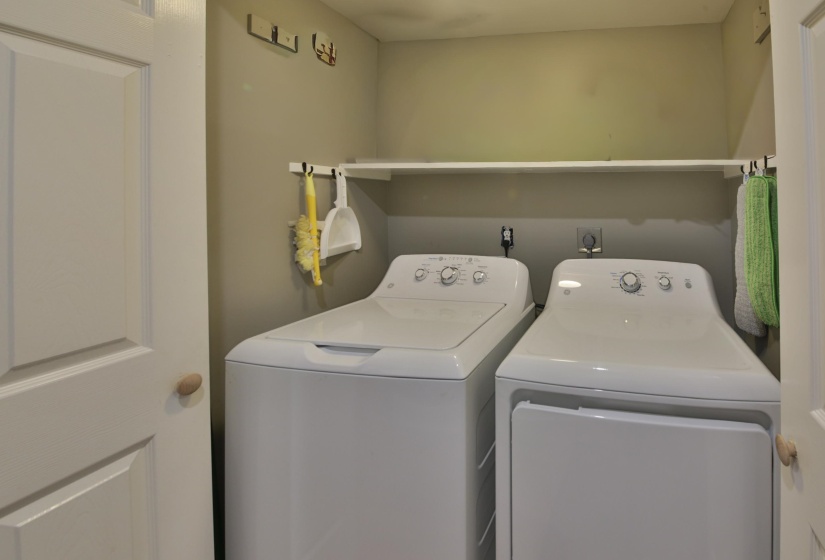Dedicated laundry area featuring a white top-load washer and dryer set