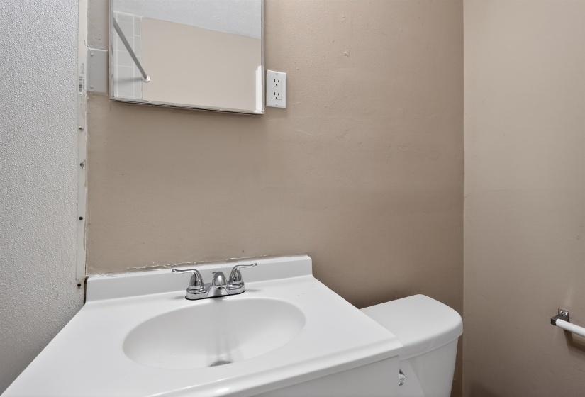 Integrated white vanity with a single basin sink and chrome-finish faucet