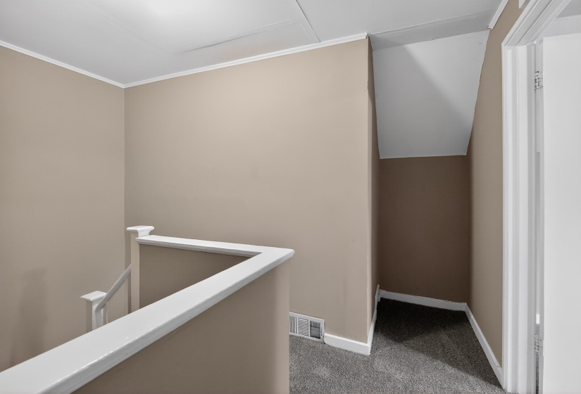 Neutral-toned walls complement white trim and a contrasting carpeted floor