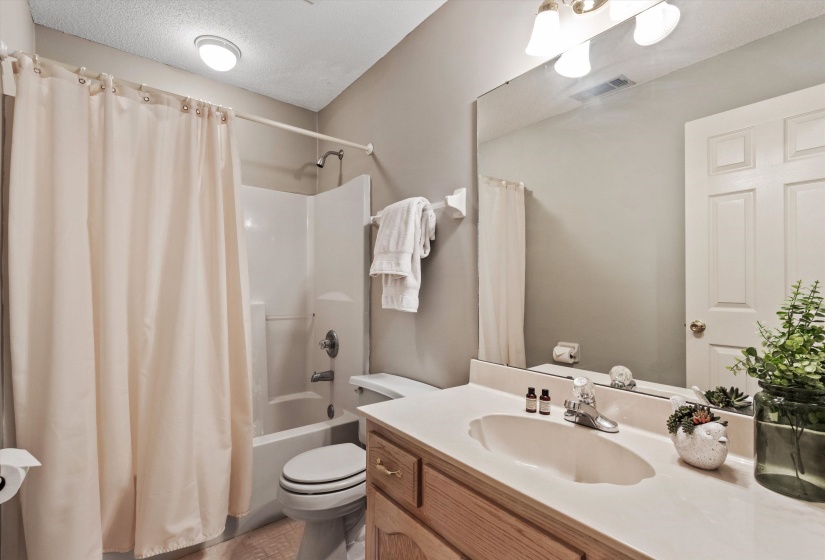 Bathroom featuring a vanity with a light-toned countertop, a built-in sink, and a chrome faucet