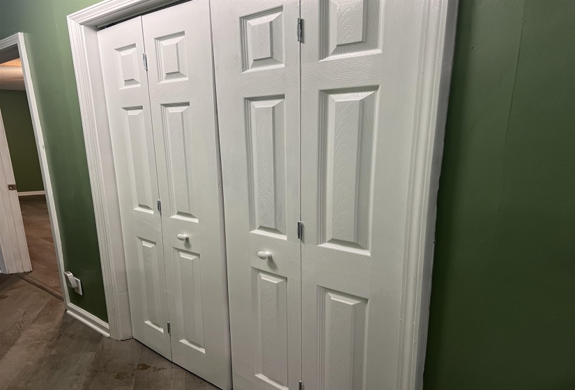 White bi-fold closet doors with panel detailing