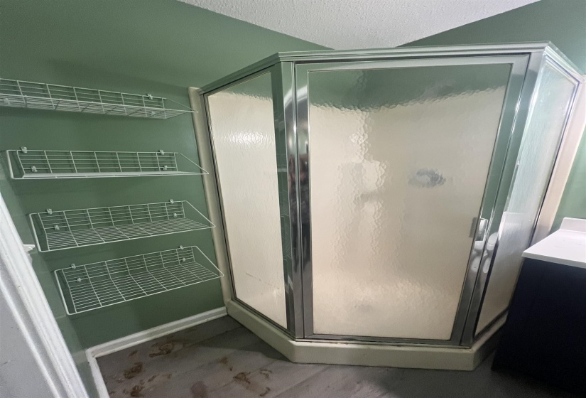 Corner shower enclosure with frosted glass panels and chrome trim in 2nd primary.
