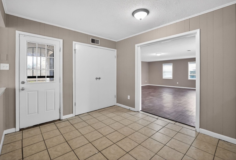 Entry area with ceramic tile flooring, a glass-paned door, bi-fold closet doors, and recessed lighting