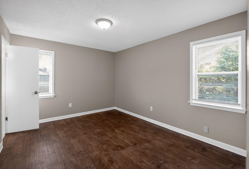 Room featuring wood-finish flooring and neutral wall tones