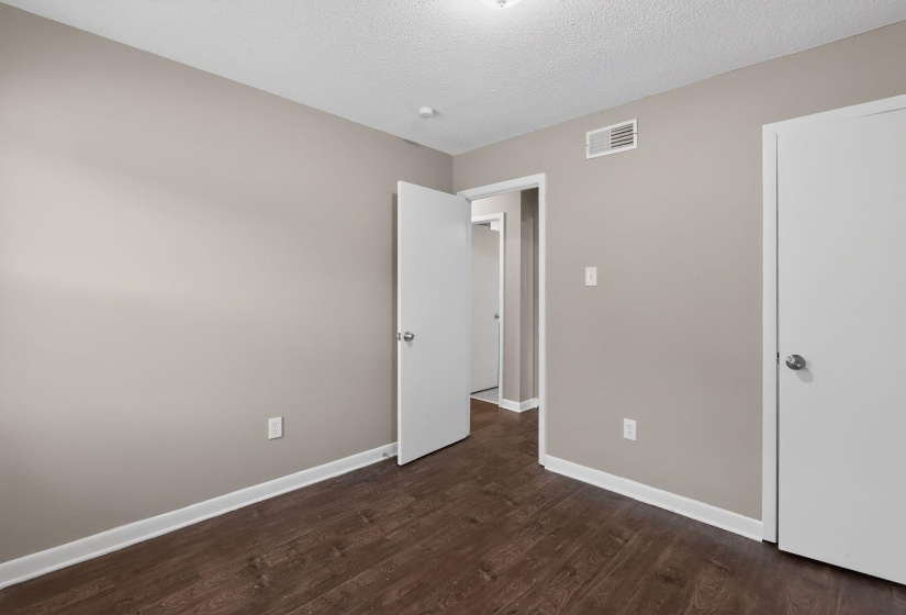 Interior room featuring wood-finish flooring and neutral painted walls