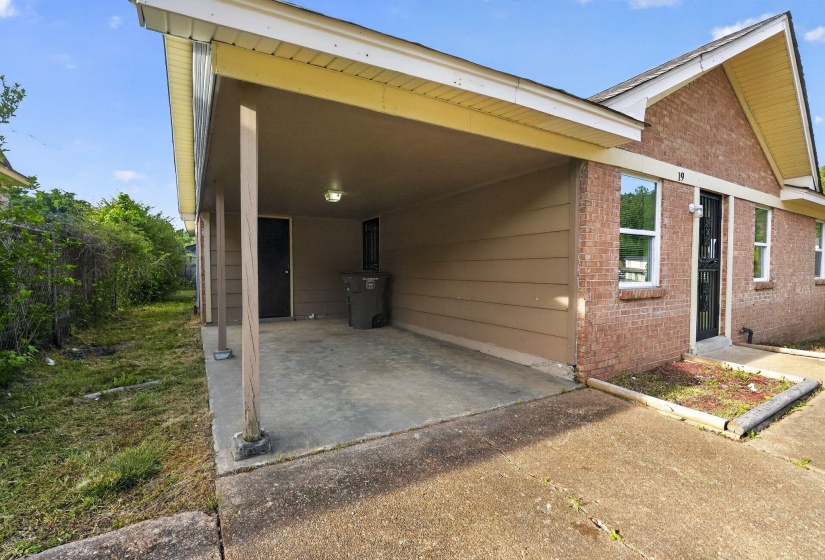 Carport entrance featuring a concrete pad and recessed lighting