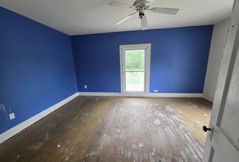 Room featuring a single window, white trim, and a ceiling fan