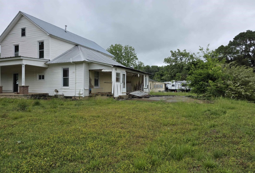 White siding exterior with a pitched metal roof