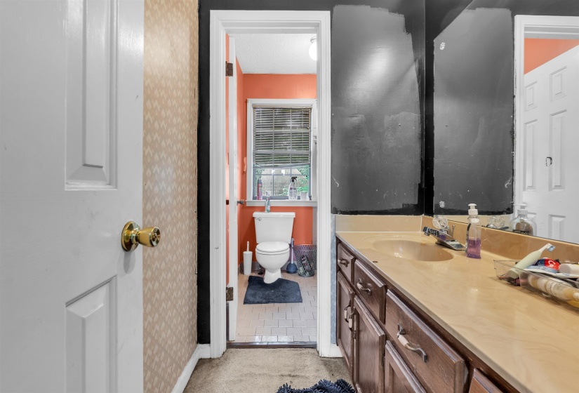 Bathroom featuring a double vanity with an integrated sink and wood-finish cabinetry