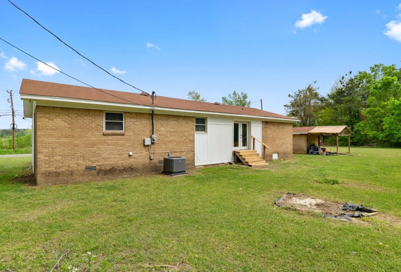 Brick exterior with white siding accents and a brown shingle roof