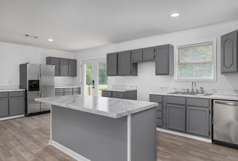 Kitchen featuring gray cabinetry, light wood-finish flooring, and white countertops with gray veining