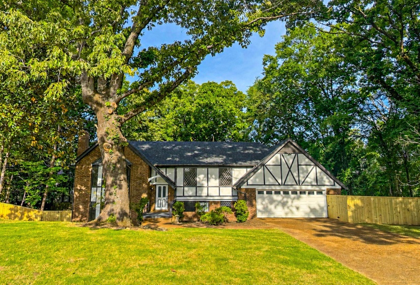 Tudor-style residence with a brick and white facade, accented by dark timber detailing