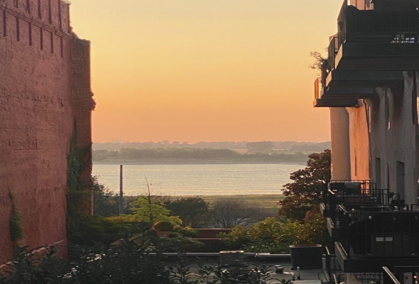 Waterfront scenery framed by historic brick architecture and modern balconies