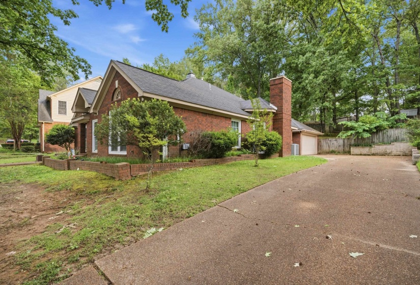 Traditional brick exterior with a gable roofline, featuring a prominent brick chimney