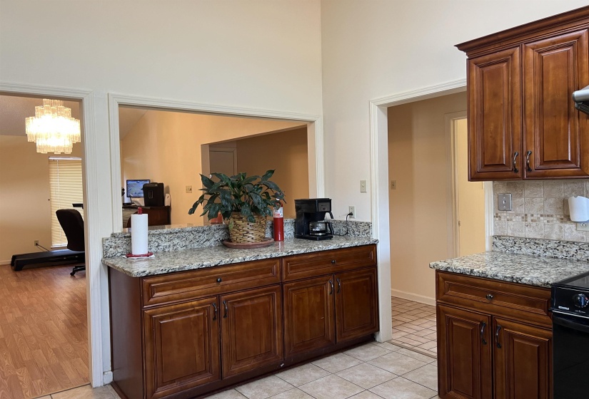 Kitchen featuring tasteful backsplash, range, beautiful cabinetry and Granite countertops