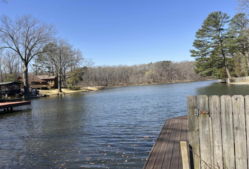 View of dock with a water view and a view of trees