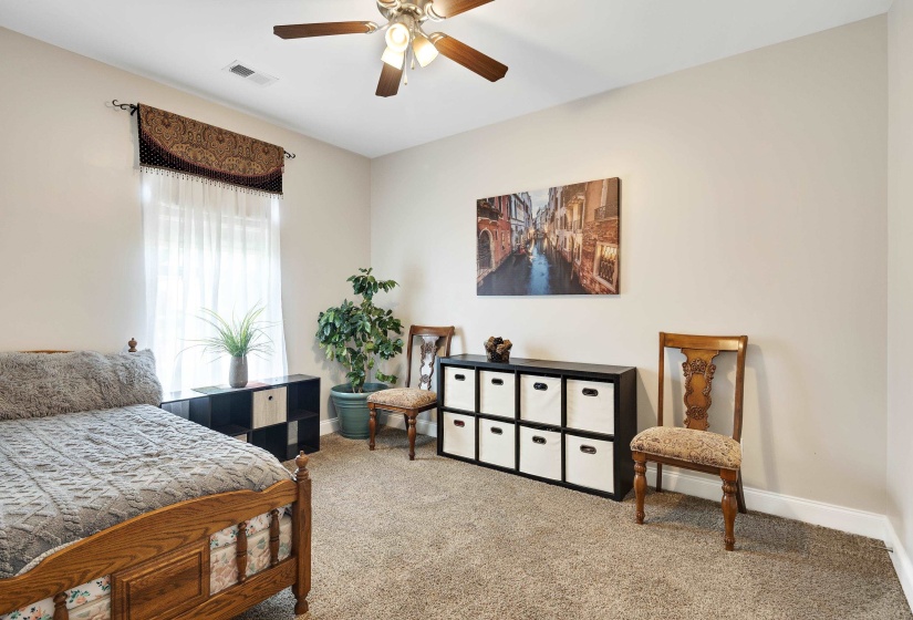 Neutral-toned walls complement the carpeted flooring